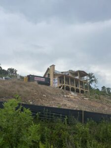 Roll Off Dumpster at New Home Build on a hill