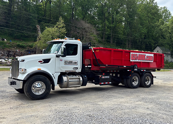 commercial roll off dumpster truck loaded with a 15 cubic yard dumpster